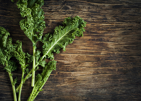 Fresh Green Kale on wooden background