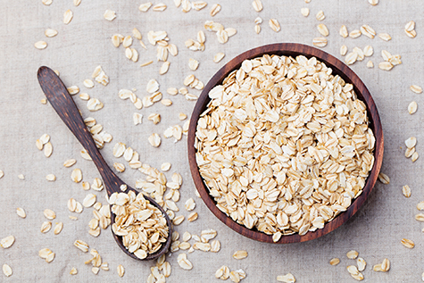Healthy breakfast Organic oat flakes in a wooden bowl