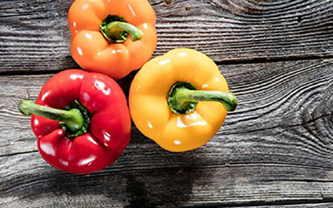 colorful bell peppers on authentic old wood copy space