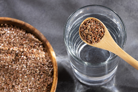 Spoon with flaxseeds to mix with water - Linum usitatissimum
