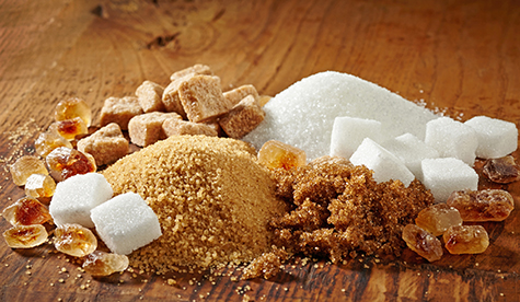 various types of sugar on wooden table