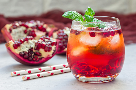 Mojito cocktail with pomegranate, mint, lemon juice and ice, horizontal