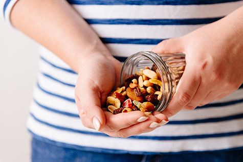 Nuts and dried fruits in hands. Cooking