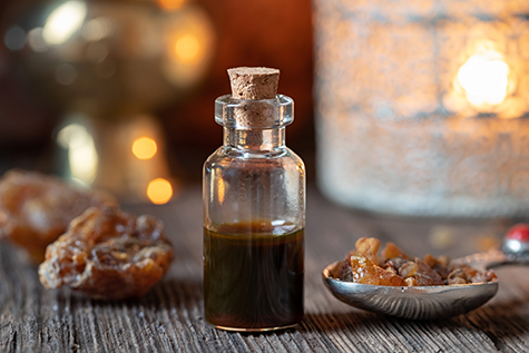 A bottle of myrrh essential oil with myrrh resin
