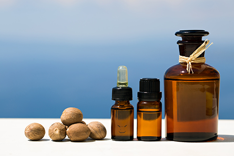 Aromatherapy essential oils in bottles and nutmegs