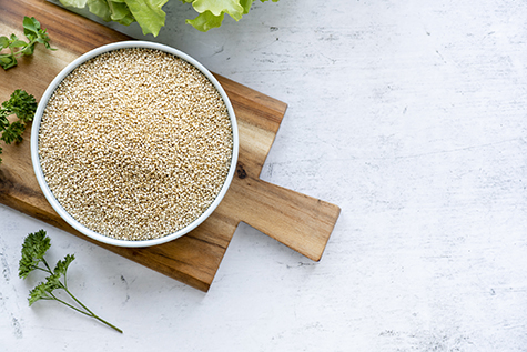 Dry white quinoa seeds in a bowl.