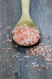 Wooden Spoonful of Pink Himalayan Salt on Rustic Wood Background with text space