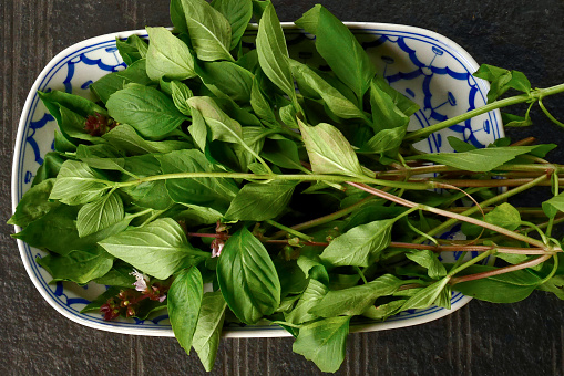 Thai basil put on dish with black table background