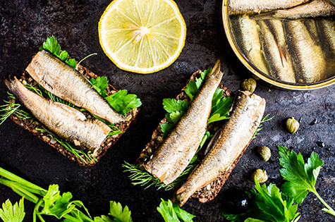 A sandwich with sardines and cilantro