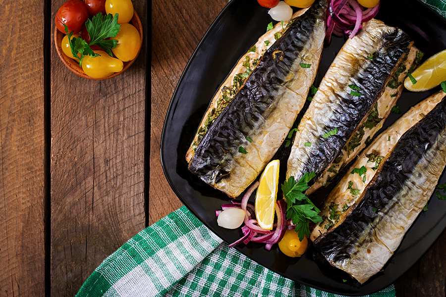 Baked mackerel with herbs and garnished with lemon