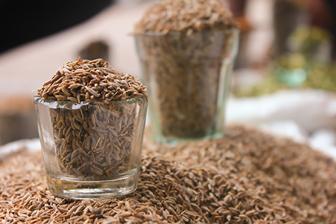 cumin seeds in glass at local market, indian spices