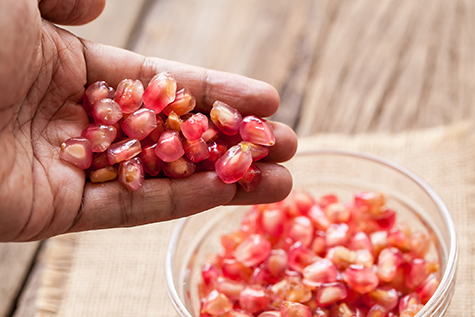 Pomegranate in a man hand