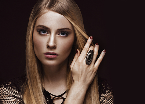Beautiful blond woman with healthy skin and hair, red manicure