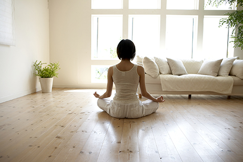 Young woman performing yoga pose in living room