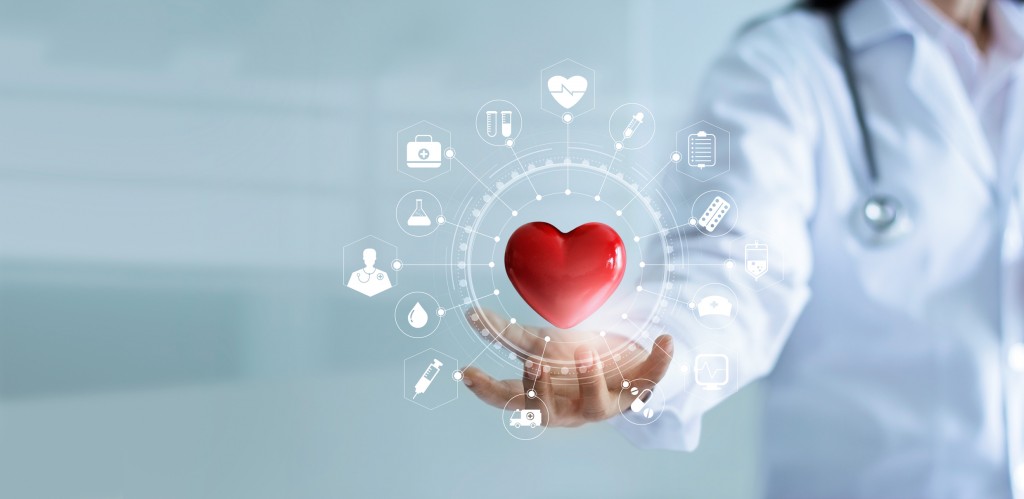 Medicine doctor holding red heart shape in hand with medical icon network connection modern virtual screen interface, service mind and medical technology network concept