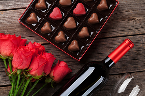 Valentines day with red roses, wine and chocolate