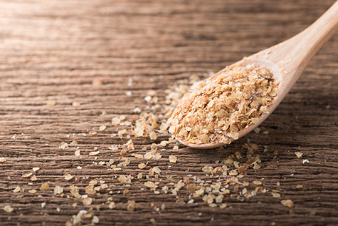 Wheat germ on wood spoon